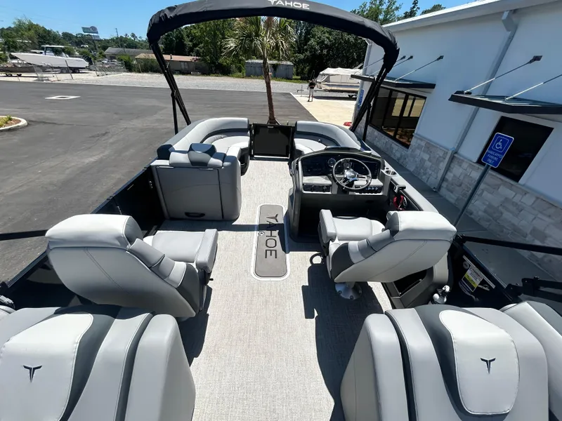Slide: The Image of 2025 Tahoe LTZ QL25T pontoon boat interior with plush seating and modern dashboard. - 12