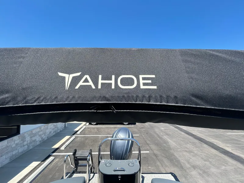 Slide: The Image of 2025 Tahoe LTZ QL25T boat with canopy, parked under clear blue sky. - 19