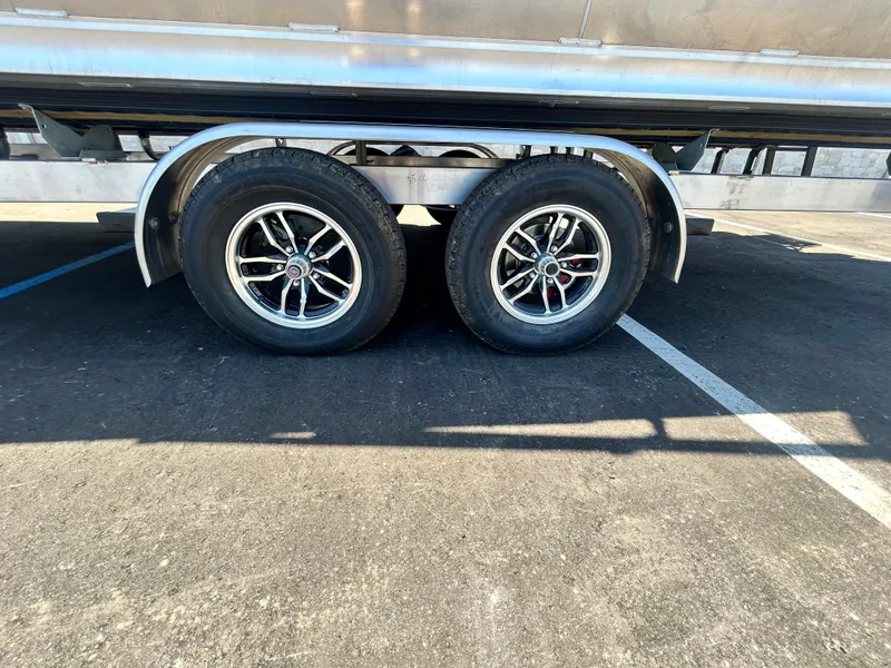 Slide: The Image of Dual wheels on a 2025 Tahoe LTZ QL25T trailer in a parking lot. - 24