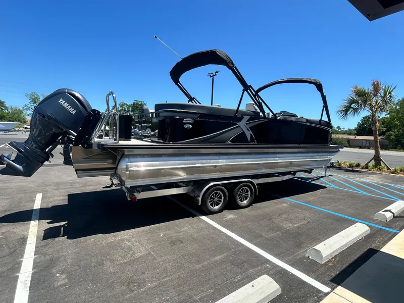 Slide: The Image of 2025 Tahoe LTZ QL25T pontoon boat with Yamaha engine on trailer in parking lot. - 5