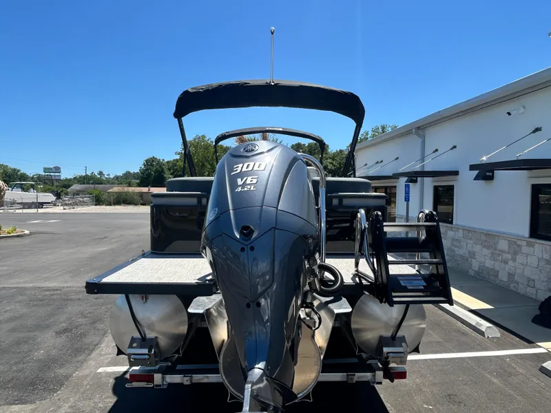 Slide: The Image of 2025 Tahoe LTZ QL25T boat with 300 V6 engine, parked outdoors under clear blue sky. - 6