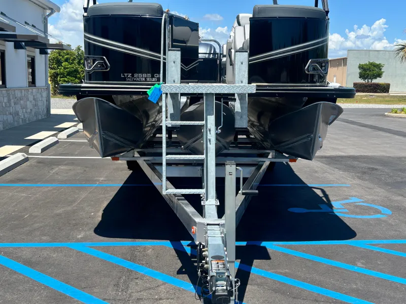 Slide: The Image of 2025 Tahoe LTZ QL25T boat on trailer in parking lot, sunny day. - 8