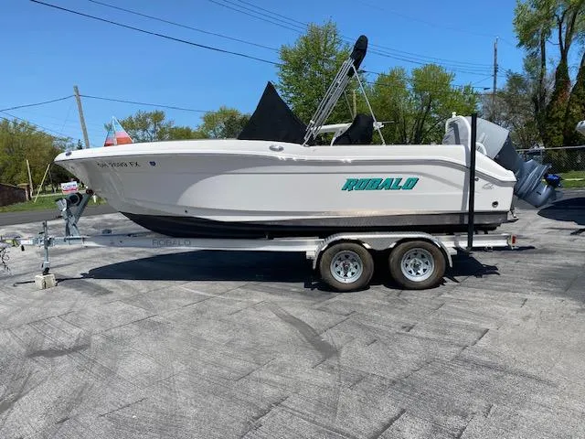 Slide: The Image of 2019 Robalo R200 Center Console boat on trailer, parked outdoors. - 1