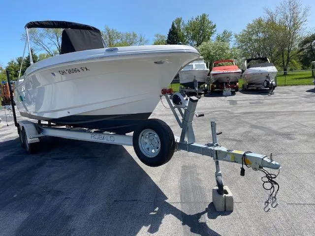 Slide: The Image of 2019 Robalo R200 Center Console boat on trailer in sunny outdoor setting. - 3
