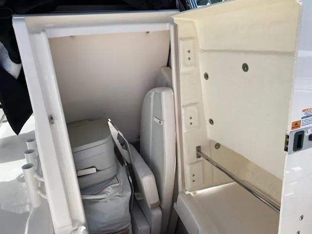 Slide: The Image of 2019 Robalo R200 Center Console storage compartment with seating and equipment. - 6