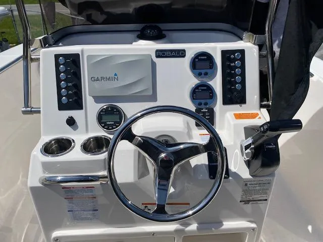 Slide: The Image of 2019 Robalo R200 Center Console dashboard with Garmin display and controls. - 7