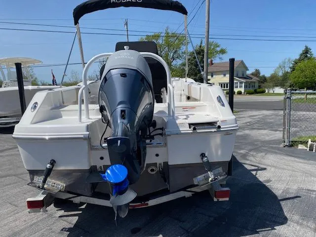 Slide: The Image of 2019 Robalo R200 Center Console boat with outboard motor, parked on a driveway. - 9