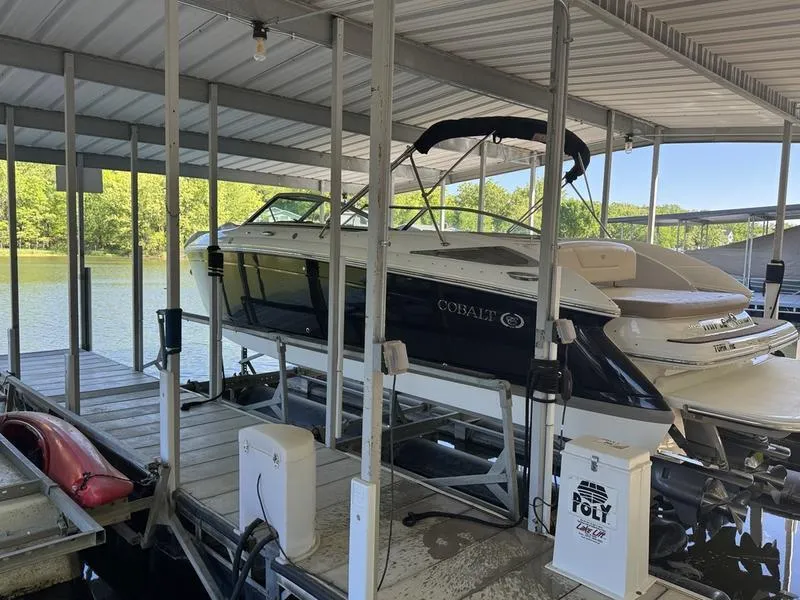 The Image of 2010 Cobalt 302 boat docked in a covered marina. - 0