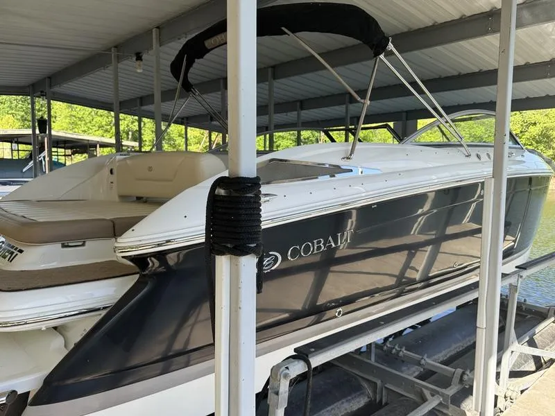 Slide: The Image of 2010 Cobalt 302 boat docked under a covered marina. - 1