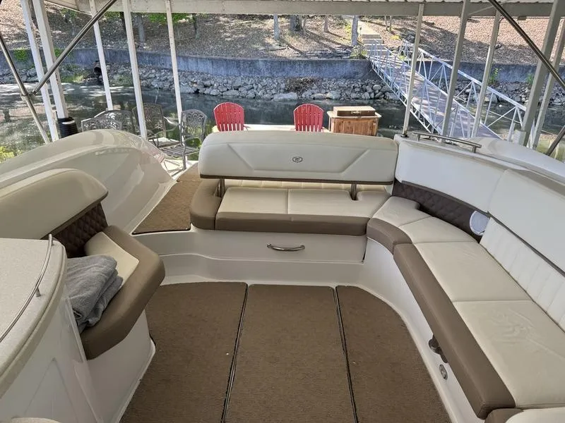 Slide: The Image of Luxurious seating area on a 2010 Cobalt 302 boat, featuring beige and brown upholstery. - 14