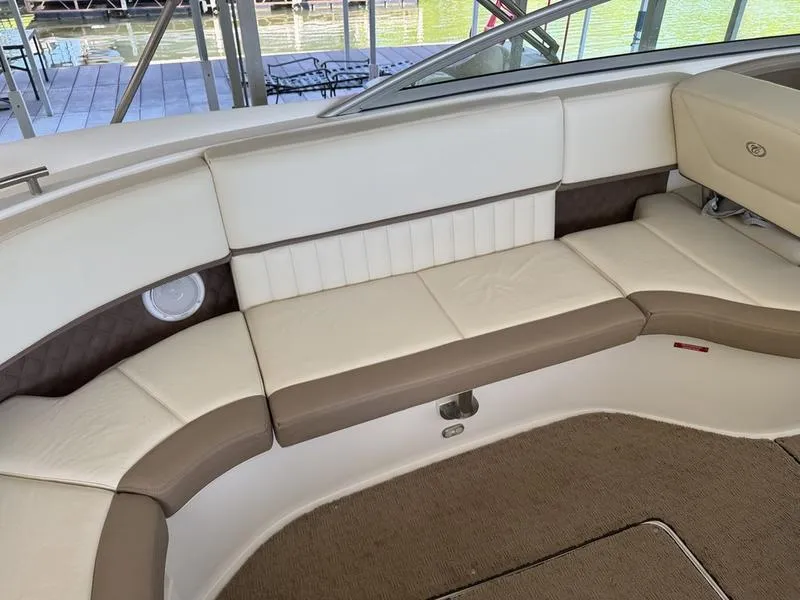 Slide: The Image of 2010 Cobalt 302 boat interior with beige and brown seating, dockside view. - 15