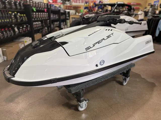 Slide: The Image of 2025 Yamaha Waverunner Superjet in showroom, sleek white design on display stand. - 3