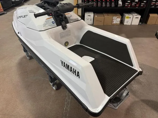 Slide: The Image of 2025 Yamaha Waverunners Superjet, white, displayed indoors on a showroom floor. - 5