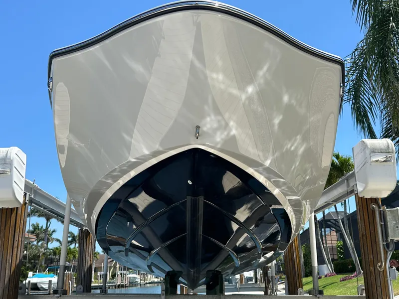 Slide: The Image of 2023 Yamaha Boats 275 SDX, sleek hull design, docked under clear blue sky. - 16