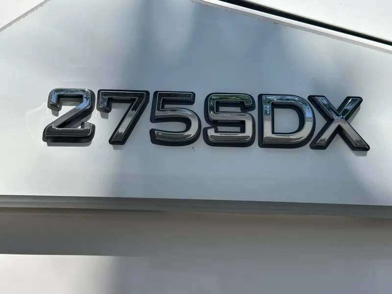 Slide: The Image of 2023 Yamaha Boats 275 SDX model emblem on white surface. - 18