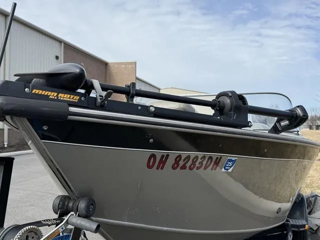 Slide: The Image of 2002 Tracker 185 Targa boat with Minn Kota trolling motor, parked outdoors. - 3