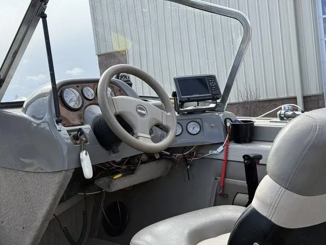 Slide: The Image of Interior of a 2002 Tracker 185 Targa boat with steering wheel and dashboard controls. - 6