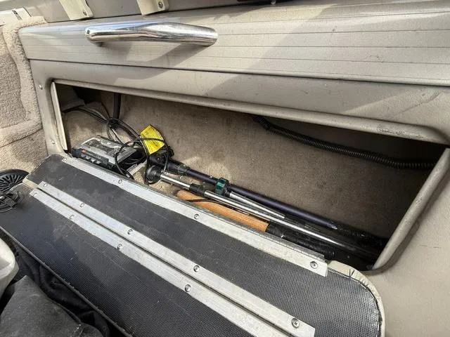Slide: The Image of Storage compartment in a 2002 Tracker 185 Targa boat with fishing gear and equipment. - 8