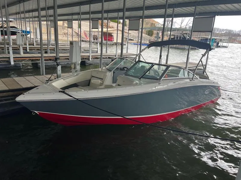 Slide: The Image of 2019 Cobalt R3 boat docked in a marina, featuring a gray and red exterior. - 1