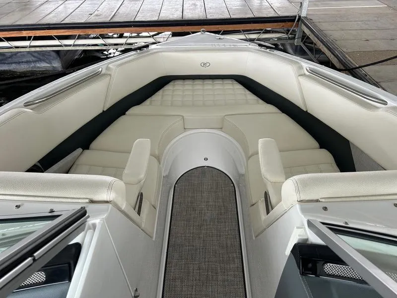 Slide: The Image of 2019 Cobalt R3 boat interior with white cushioned seating and gray flooring. - 10