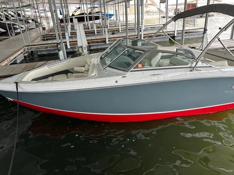 Slide: The Image of 2019 Cobalt R3 boat docked in marina, gray hull with red trim. - 4