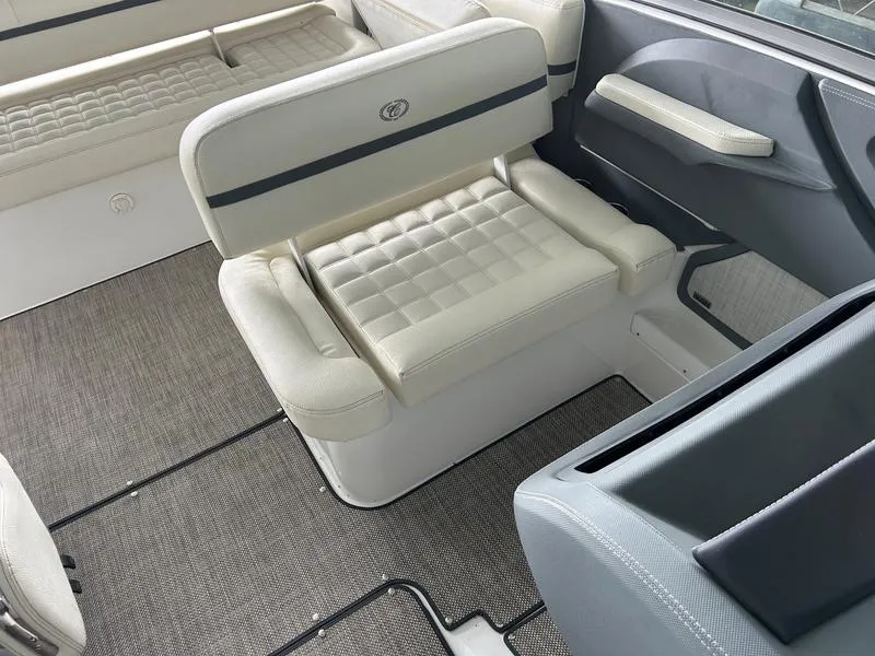 Slide: The Image of 2019 Cobalt R3 boat interior with white cushioned seating and gray flooring. - 6