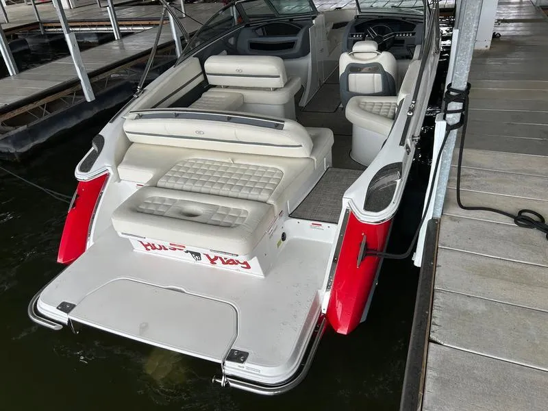 Slide: The Image of 2019 Cobalt R3 boat with white and red exterior, docked at a marina. - 8