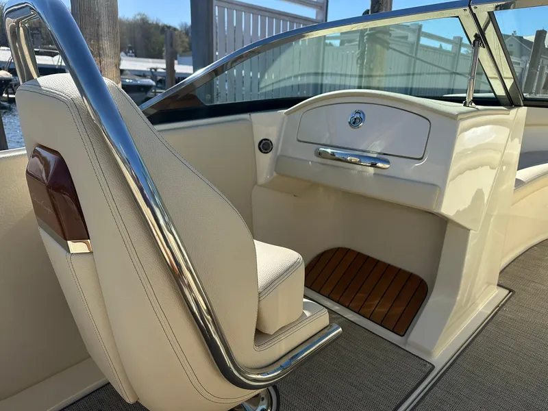 Slide: The Image of 2022 Chris-Craft Launch 23 boat interior with elegant seating and wooden accents. - 10