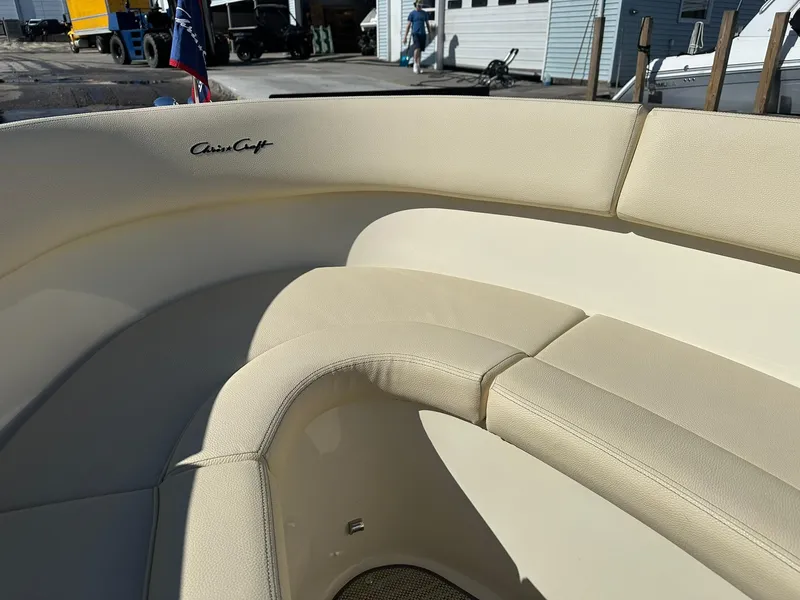 Slide: The Image of 2022 Chris-Craft Launch 23 boat interior with beige seating and logo detail. - 15