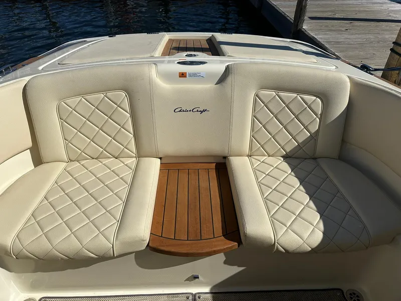 Slide: The Image of 2022 Chris-Craft Launch 23 boat interior with beige quilted seats and wooden accents. - 21