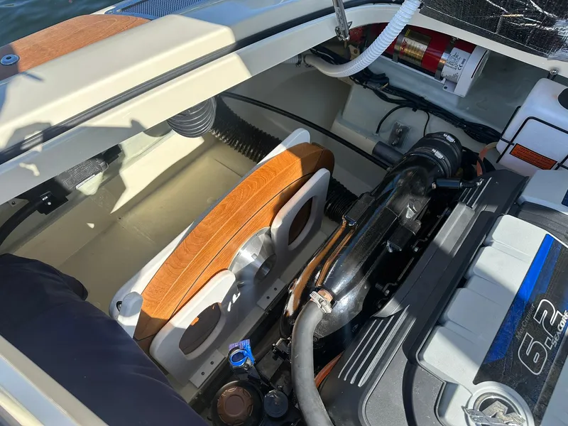 Slide: The Image of 2022 Chris-Craft Launch 23 engine compartment with visible components and storage area. - 23