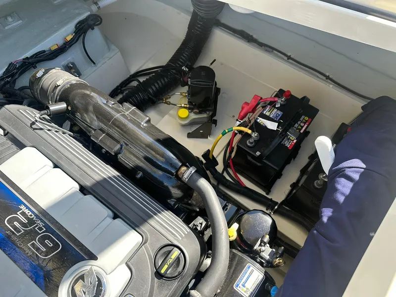 Slide: The Image of Engine compartment of 2022 Chris-Craft Launch 23 boat, featuring battery and wiring. - 24