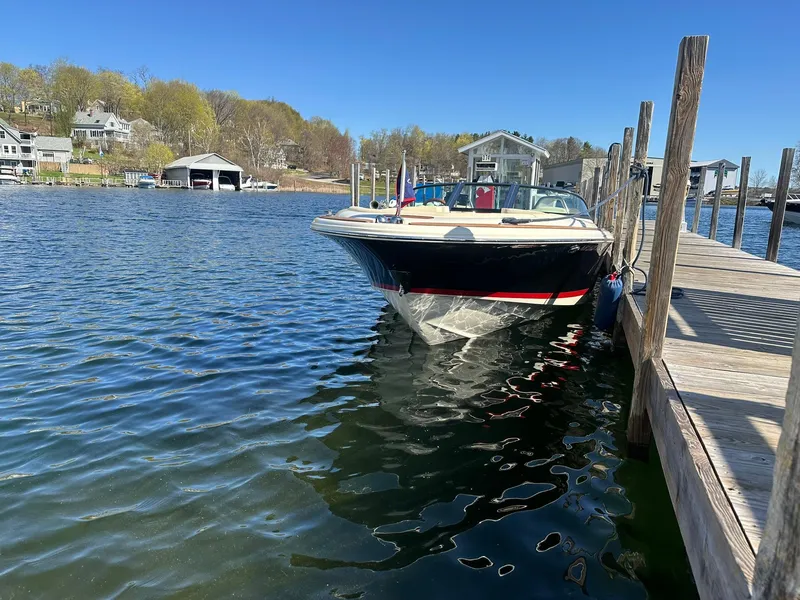 Slide: The Image of 2022 Chris-Craft Launch 23 docked on a sunny day by a wooden pier. - 4