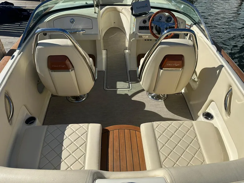 Slide: The Image of 2022 Chris-Craft Launch 23 boat interior with elegant seating and wooden accents. - 9