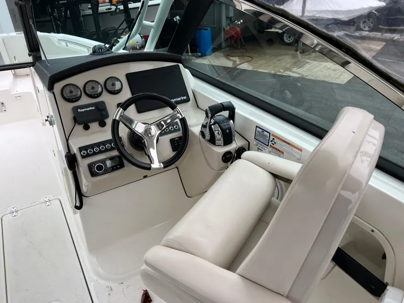 Slide: The Image of 2017 Boston Whaler 270 Vantage boat cockpit with steering wheel and control panel. - 3