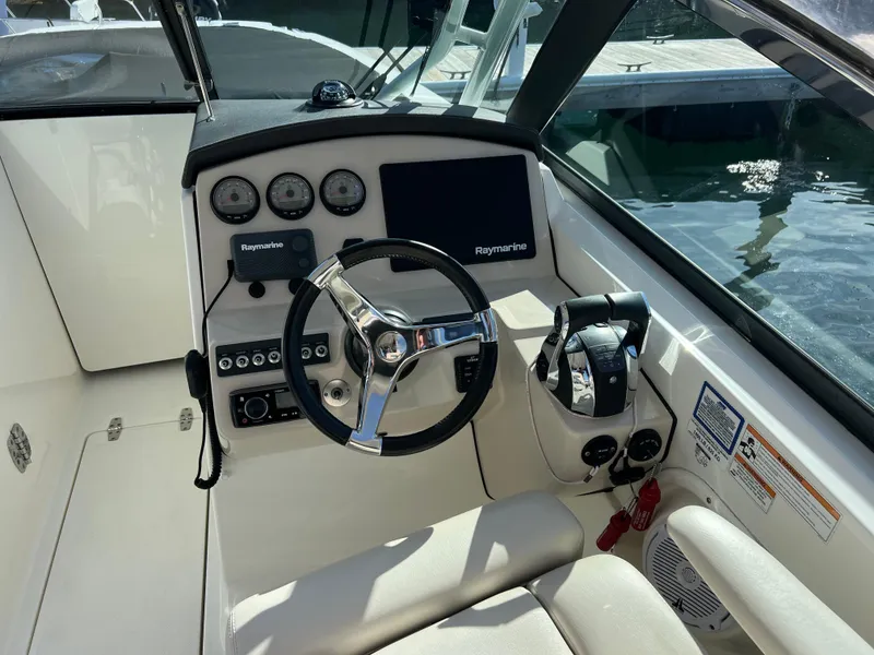 Slide: The Image of 2017 Boston Whaler 270 Vantage boat cockpit with steering wheel and control panel. - 5