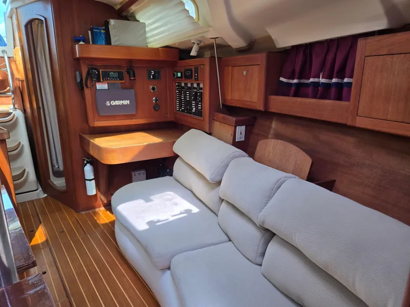 Slide: The Image of Interior of 2002 Hunter 380 sailboat with cozy seating and navigation equipment. - 11