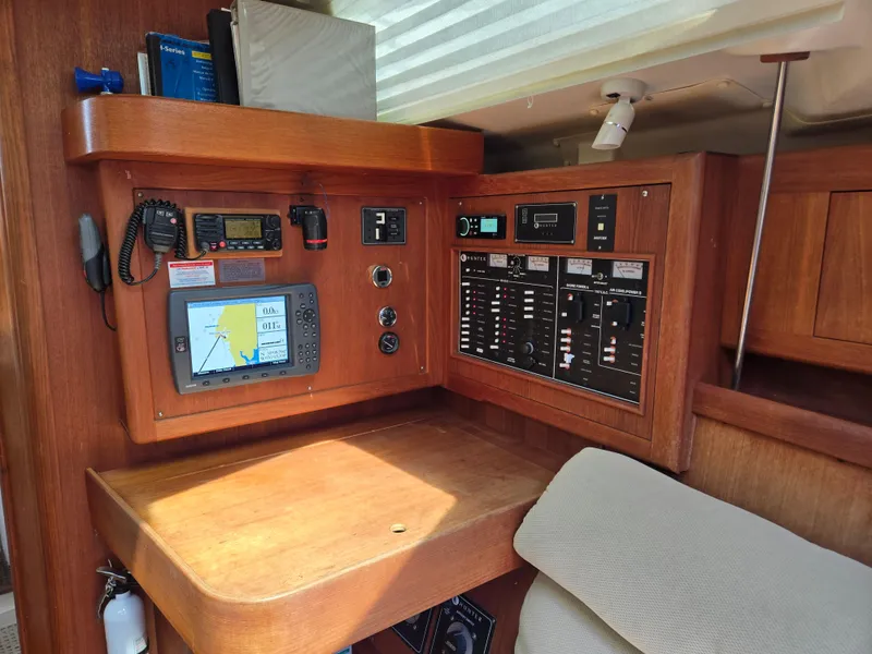 Slide: The Image of Navigation station of a 2002 Hunter 380 sailboat with electronic controls and chart plotter. - 12