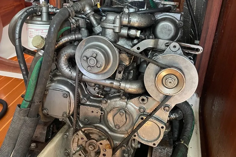 Slide: The Image of Engine of a 2002 Hunter 380 sailboat with visible belts and hoses. - 16