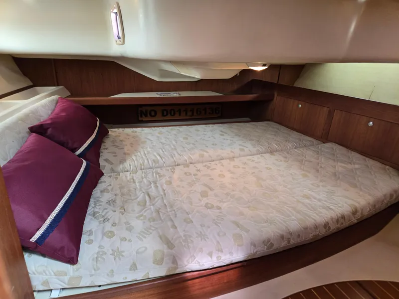 Slide: The Image of Cozy cabin interior of 2002 Hunter 380 sailboat with comfortable bedding and wooden accents. - 19