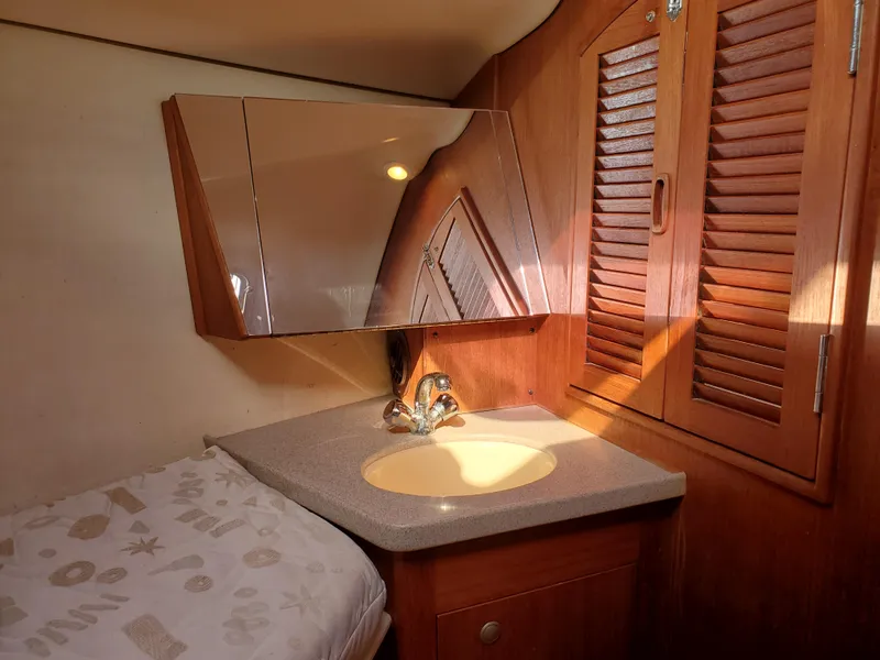 Slide: The Image of Interior of 2002 Hunter 380 yacht with wooden cabinetry and compact sink area. - 20