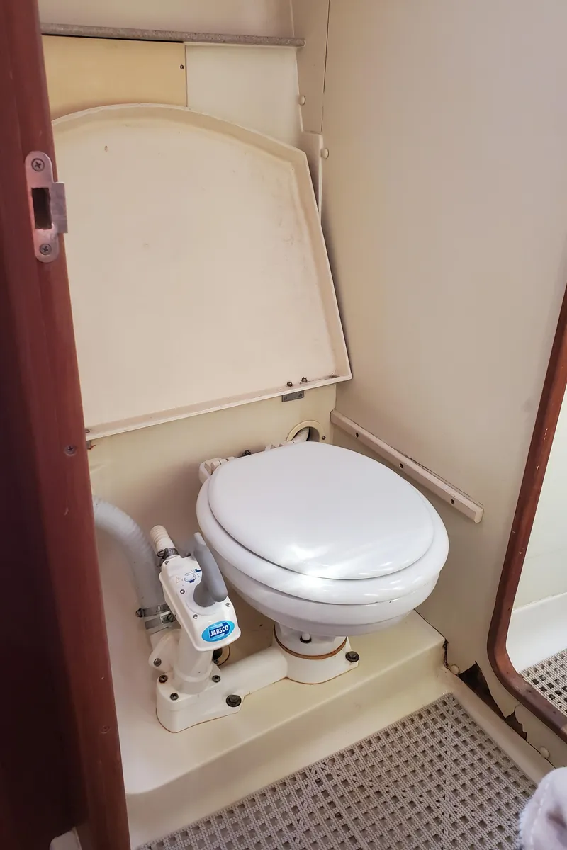 Slide: The Image of Compact marine toilet in a 2002 Hunter 380 sailboat bathroom. - 22