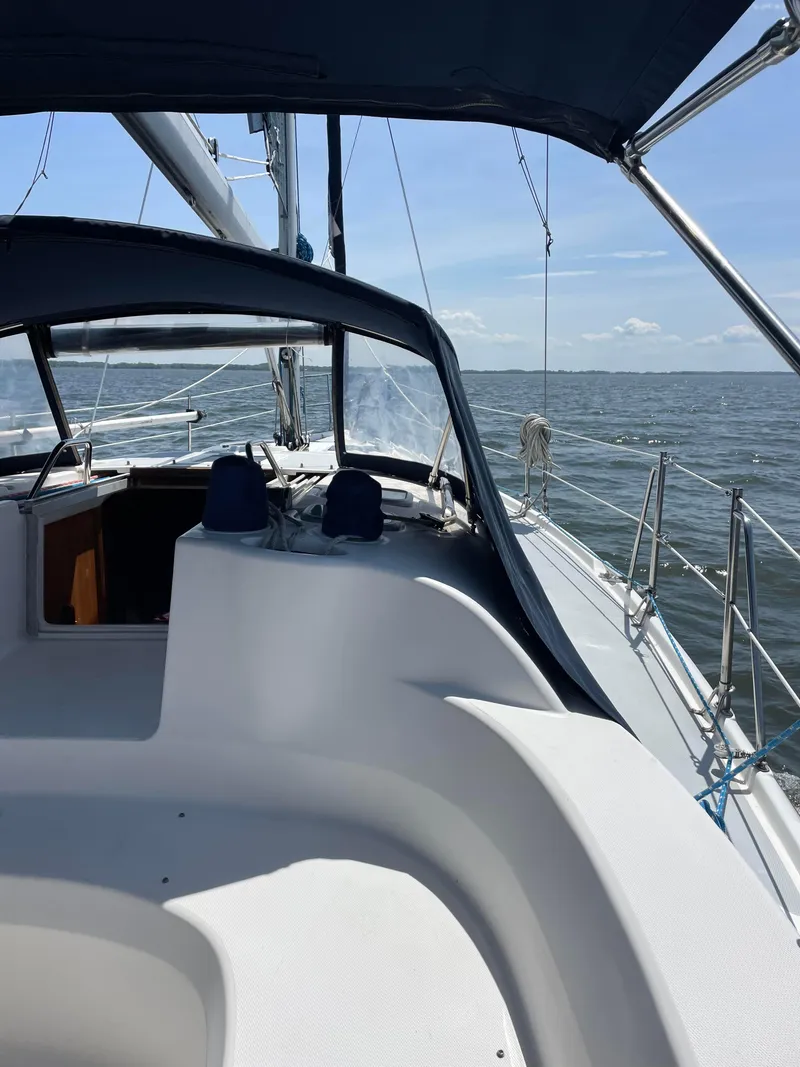 Slide: The Image of 2002 Hunter 380 sailboat on open water under clear skies. - 26