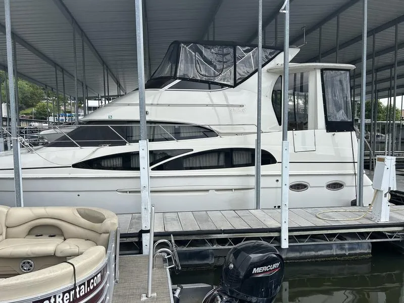 The Image of 2005 Carver 396 AFT yacht docked under covered marina. - 1