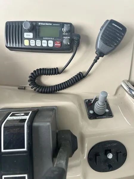 Slide: The Image of Control panel of a 2005 Carver 396 AFT boat with radio and throttle. - 13