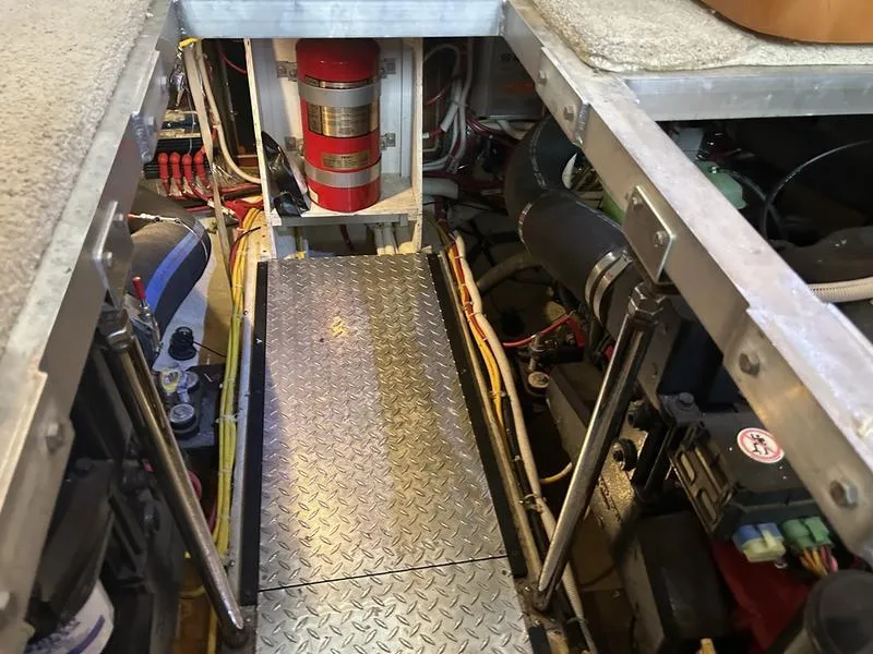 Slide: The Image of Engine room of 2005 Carver 396 AFT yacht with fire extinguisher and mechanical components. - 35