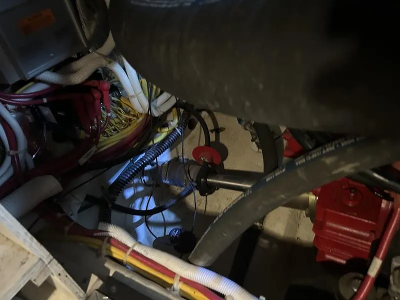 Slide: The Image of Engine compartment of 2005 Carver 396 AFT with wiring and hoses visible. - 39