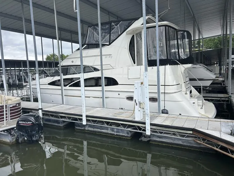 Slide: The Image of 2005 Carver 396 AFT yacht docked in a covered marina. - 4