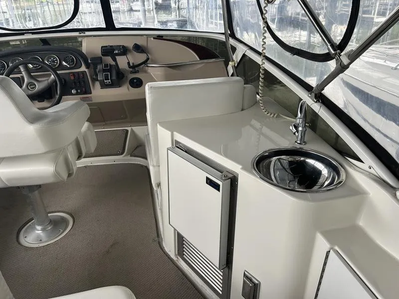 Slide: The Image of 2005 Carver 396 AFT yacht interior with helm, sink, and seating area. - 5