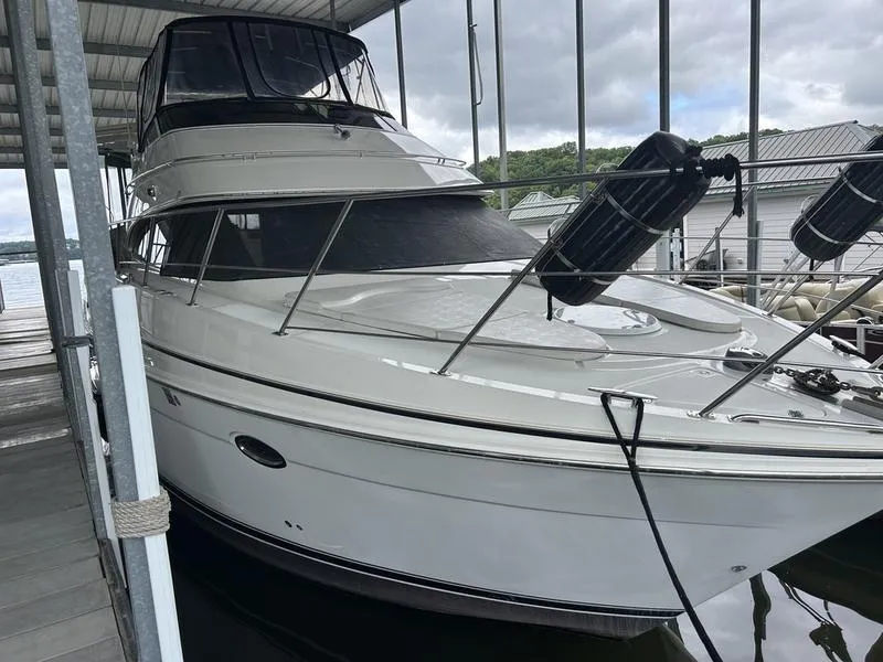 Slide: The Image of 2005 Carver 396 AFT yacht docked under a covered marina. - 9